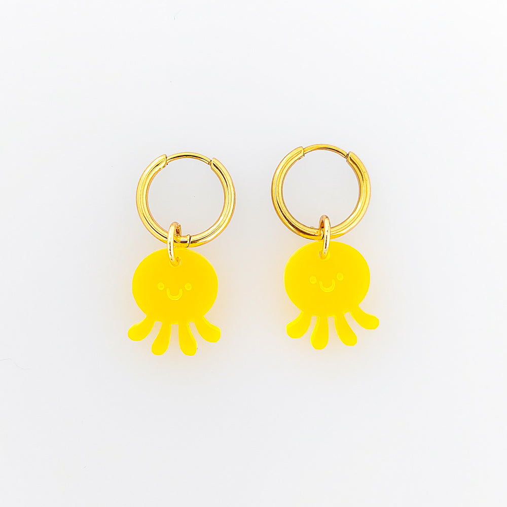 Gelbe Quallen Creolen Ohrringe mit graviertem Gesicht aus satiniertem Acrylglas und vergoldeten Edelstahl-Creolen – verspielt & leicht.