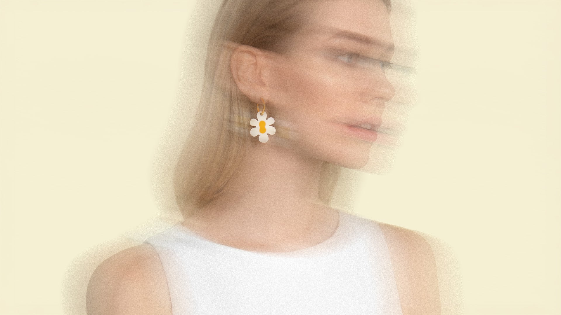 Frau trägt goldene Edelstahl Creolen mit großem Daisy Blumen Anhänger aus Acrylglas von sweeps